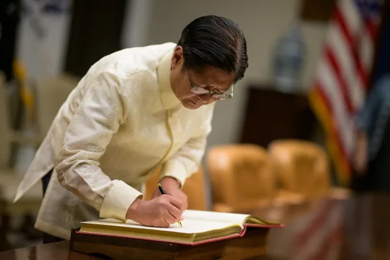 President Marcos Jr. signing an official document during his White House visit, July 22, 2025. Official White House photo.