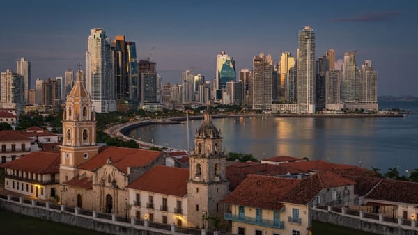 Panama City at dusk - Casco Viejo colonial old town in the foreground with the modern Punta Pacifica skyline across the Bay of Panama.