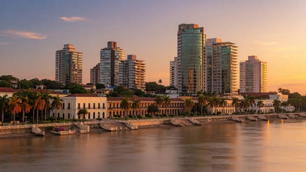 Asuncion Paraguay riverfront skyline at golden hour along the Costanera promenade with modern towers and the Paraguay River.